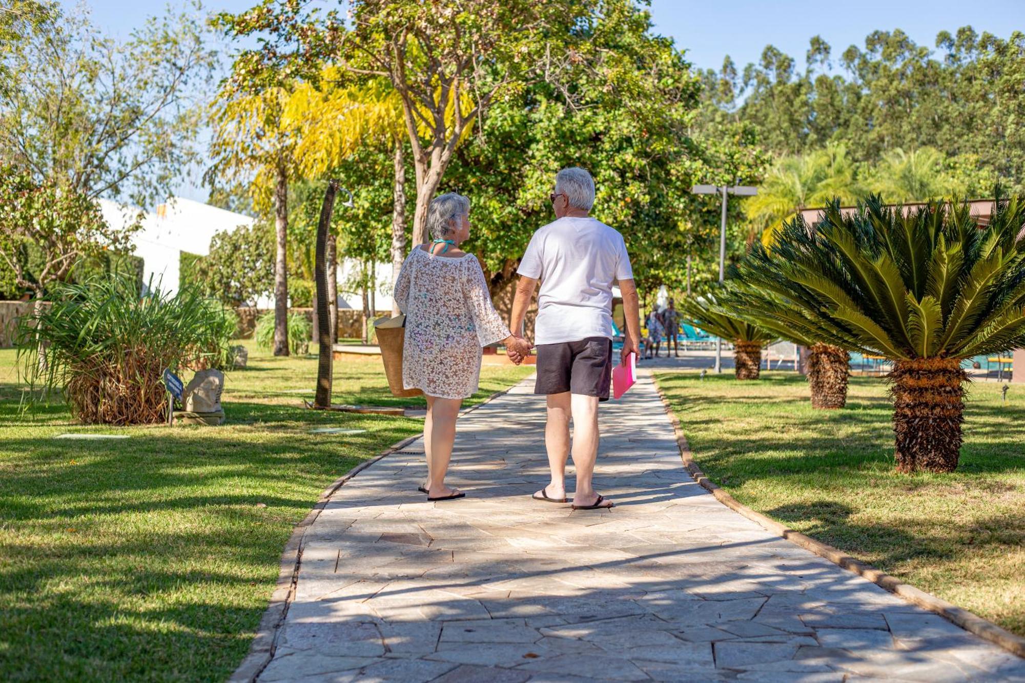 Blue Tree Thermas De Lins Resort Exteriör bild A couple walking in a park