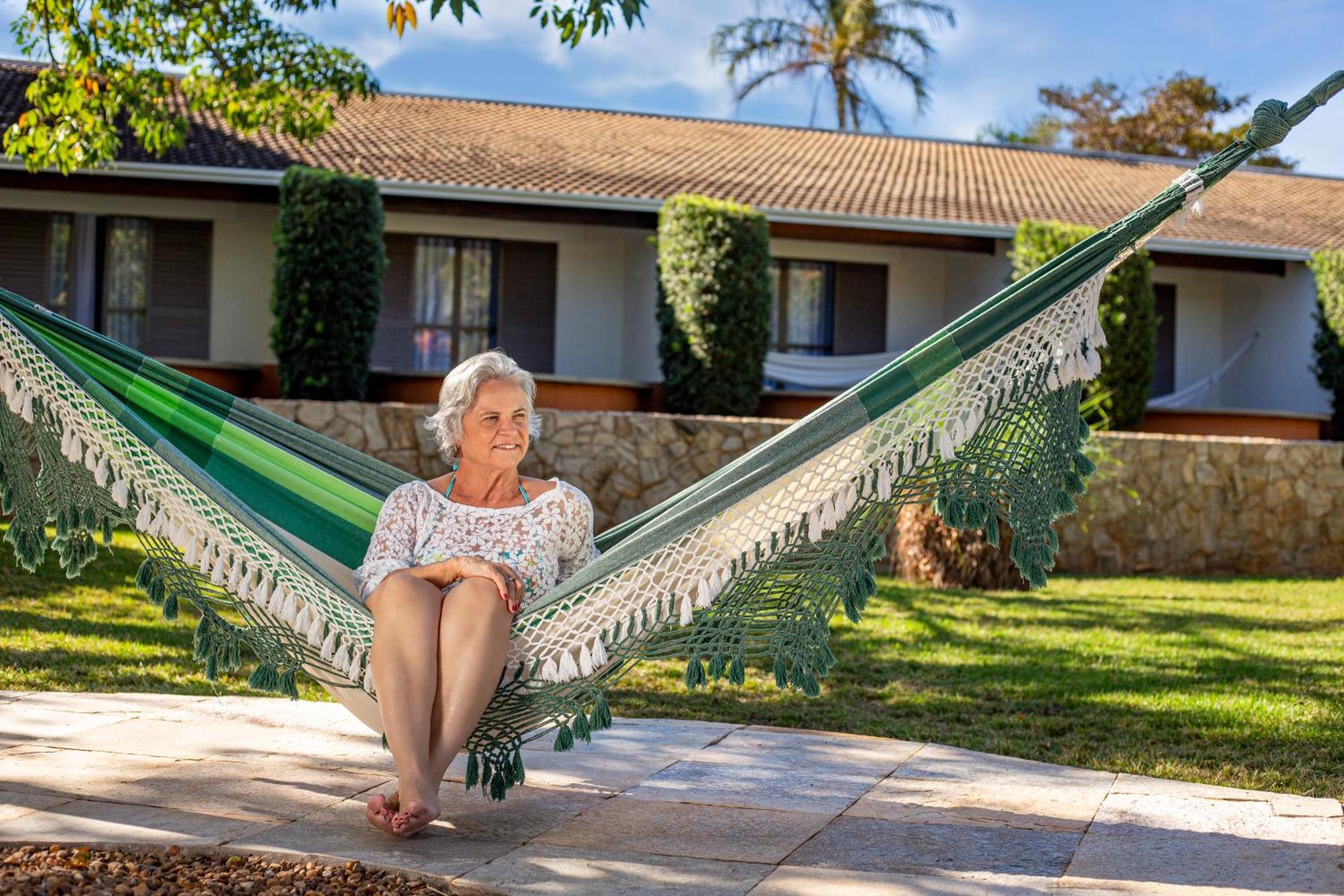 Blue Tree Thermas De Lins Resort Exteriör bild A woman relaxing in a hammock